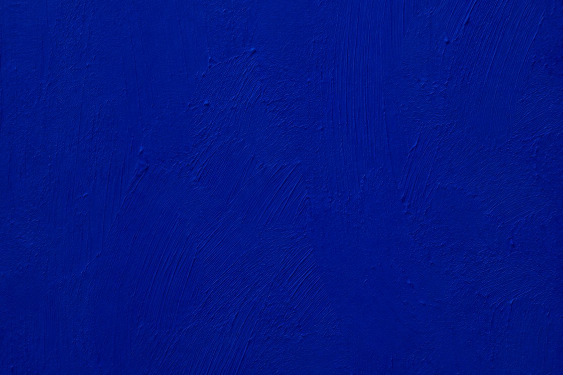 A textured field of deep ultramarine blue